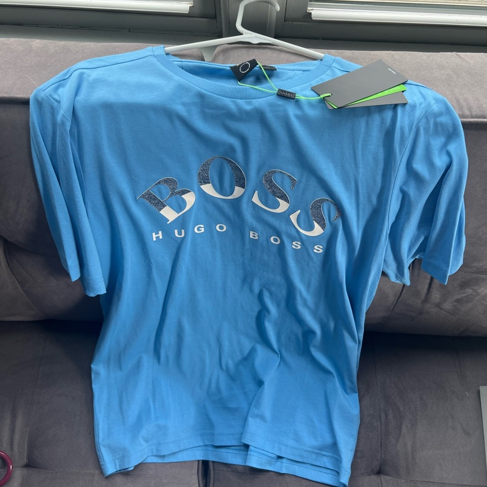 hugos boss shirt fits tight so more like a L-M